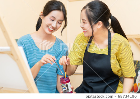 Woman painting 69734190