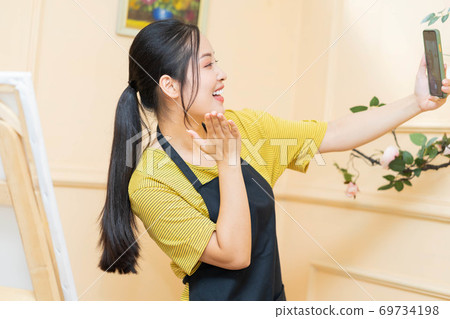 Woman painting 69734198