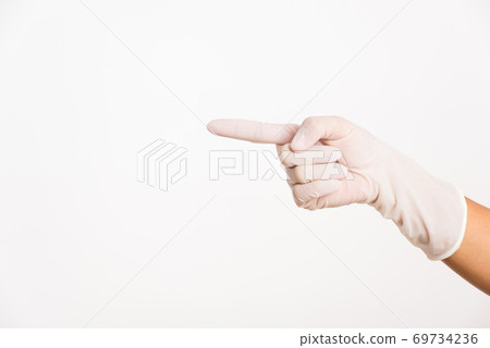 Woman wearing hand to rubber medical glove with point finger Woman wearing hand to rubber medical glove with point finger 69734236