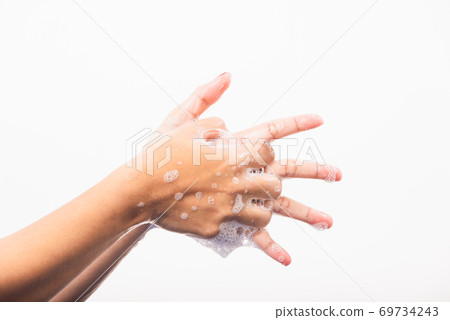 Woman washing hands by soap for cleanliness 69734243