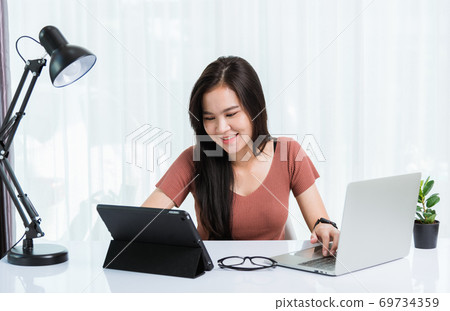 Business woman use smart tablet and laptop computer technology video call conferencing to team 69734359