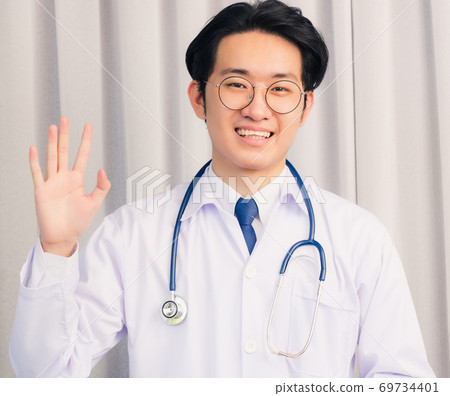 Doctor man smiling talking online video conference Doctor man smiling talking online video conference 69734401