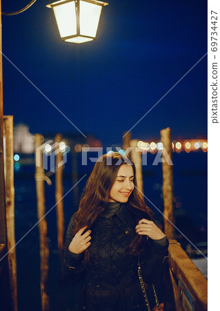 female tourist walking around and exploring venice female tourist walking around and exploring venice 69734427