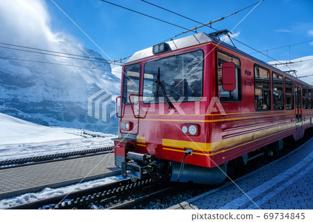 A red swiss train in Station, Switzerland 69734845