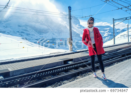 Asian woman in train station, Switzerland 69734847