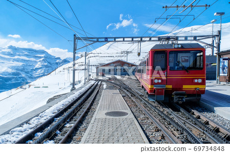 A red swiss train in Station, Switzerland 69734848
