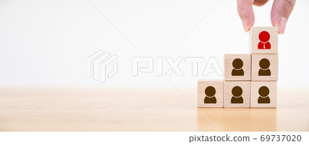 Hand putting wood cube block on top staircase Hand putting wood cube block on top staircase 69737020