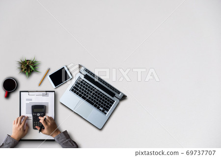 Male hands working on modern laptop. Office desktop on wooden table background. 69737707