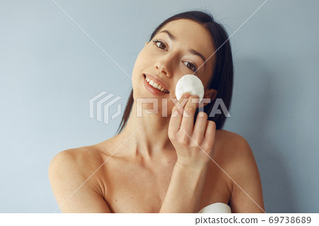 Beautiful girl standing in a studio with wadded disk Beautiful girl standing in a studio with wadded disk 69738689