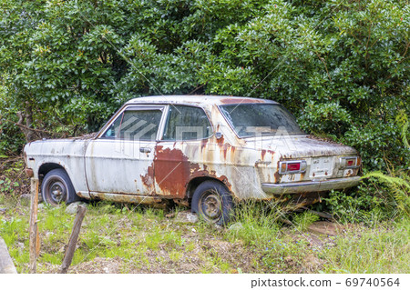 Decaying scrapped car Decaying scrapped car 69740564
