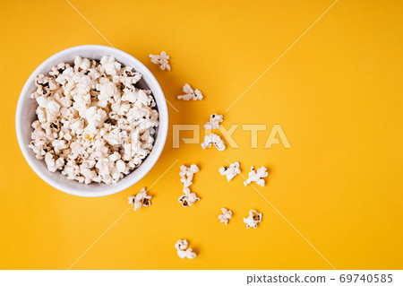 Bowl of popcorn on yellow background 69740585