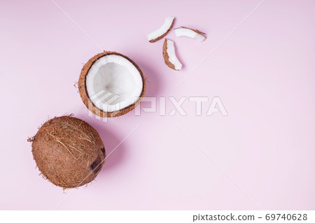Coconuts on pink background, top view. 69740628