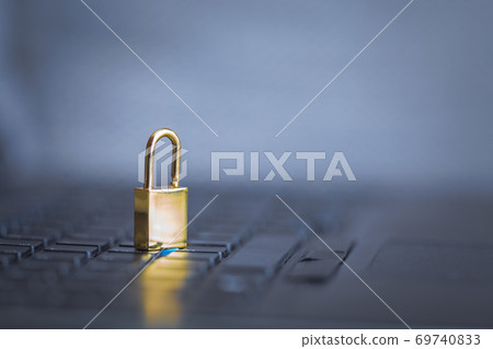 Background image of golden metal lock on keyboard, computer security 69740833