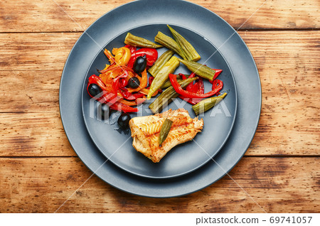 Baked fish with vegetables 69741057