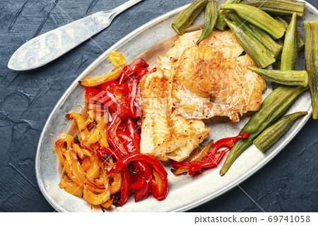 Baked fish with vegetables 69741058