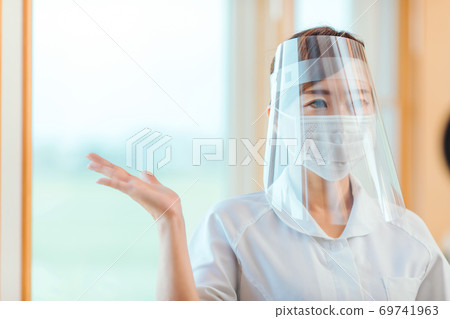 nurse asian woman with face shield 69741963