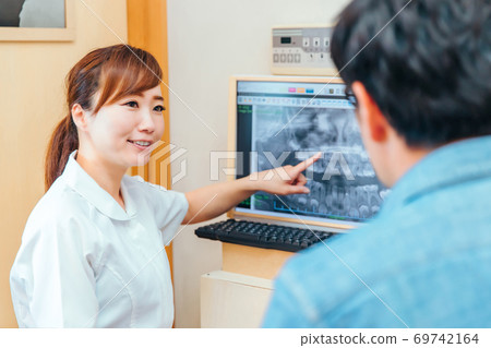 Dental hygienist and male patient Dental hygienist and male patient 69742164
