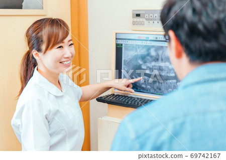 Dental hygienist and male patient Dental hygienist and male patient 69742167