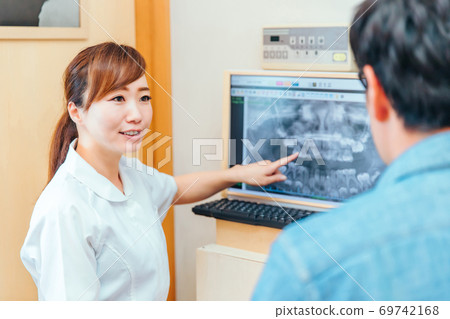 Dental hygienist and male patient Dental hygienist and male patient 69742168
