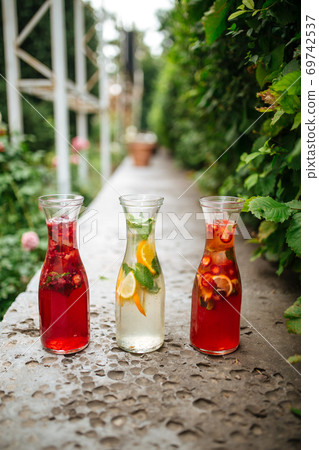 Side view on three fruit and berry lemonades Side view on three fruit and berry lemonades 69742537