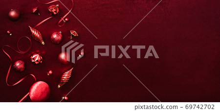 red christmas decoration bauble and ribbon on velvet red felt fabric  top view table background 69742702
