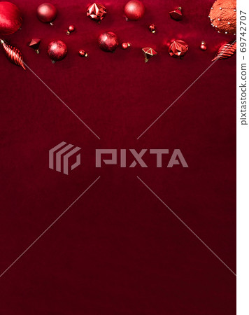red christmas decoration bauble and ribbon on velvet red felt fabric top view table backgorund.vertical layout red christmas decoration bauble and ribbon on velvet red felt fabric top view table backgorund.vertical layout 69742707
