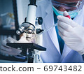 Asian male scientist Is working seriously Chemistry experiment With a microscope In the laboratory, the color tone image. 69743482