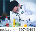 Asian male scientist Is working seriously Chemistry experiment With a microscope In the laboratory, the color tone image. 69743493