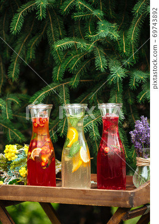 Side view on three fruit and berry lemonades Side view on three fruit and berry lemonades 69743892