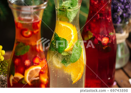 Three fruit and berry lemonades on the wooden tray 69743898
