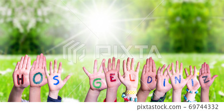 Children Hands Building Word Hos Geldiniz Means Welcome, Grass Meadow 69744332