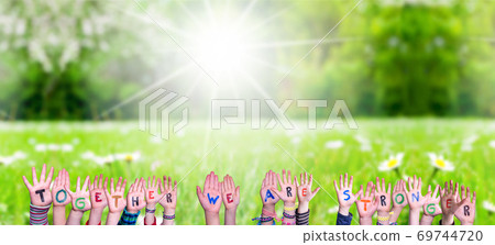 Children Hands Building Word Together We Are Stronger, Grass Meadow Children Hands Building Word Together We Are Stronger, Grass Meadow 69744720