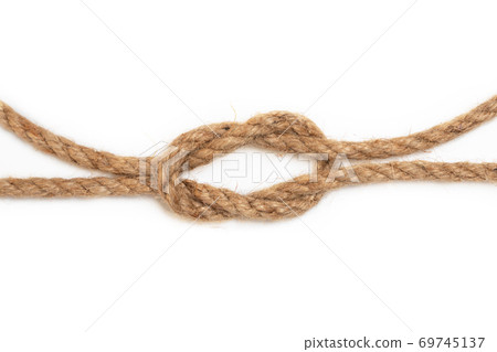 Brown jute rope with knot isolated on white background. Brown jute rope with knot isolated on white background. 69745137