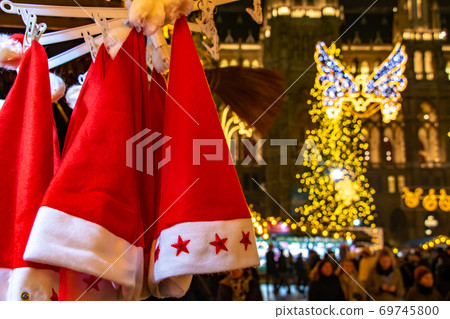 Santa Claus hats hangs on shop at The traditional Christmas market, Austria Santa Claus hats hangs on shop at The traditional Christmas market, Austria 69745800
