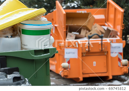 garbage in full dustbins and a container with separate waste cardboard on the street of the city garbage in full dustbins and a container with separate waste cardboard on the street of the city 69745812