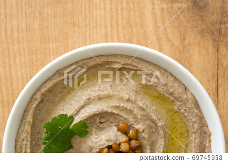 Lentil hummus in bowl on wood Lentil hummus in bowl on wood 69745958