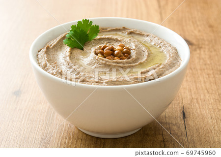 Lentil hummus in bowl on wood Lentil hummus in bowl on wood 69745960