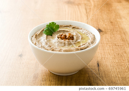 Lentil hummus in bowl on wood Lentil hummus in bowl on wood 69745961
