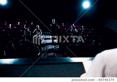 Male caucasian speaker giving presentation in hall at university or business centre workshop Male caucasian speaker giving presentation in hall at university or business centre workshop 69746374