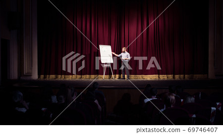 Male caucasian speaker giving presentation in hall at university or business centre workshop 69746407