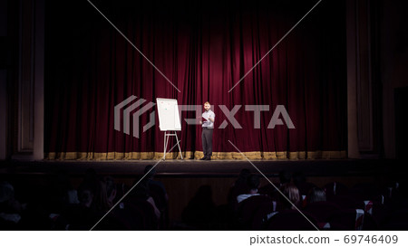 Male caucasian speaker giving presentation in hall at university or business centre workshop Male caucasian speaker giving presentation in hall at university or business centre workshop 69746409