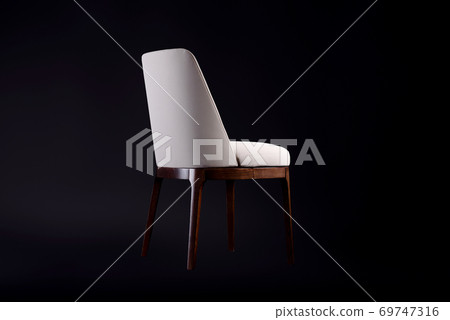 Beautiful comfortable chair with leather upholstery on a black background 69747316