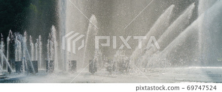 Photography of fountains and blue sky. Hot summer day in the Moscow public park.	 69747524