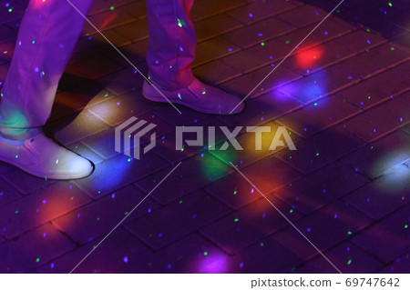 Photography of dancing people on night party in the city street in summer. Leisure, happiness, entertainment theme. Dance in bright colorful light music glares Photography of dancing people on night party in the city street in summer. Leisure, happiness, entertainment theme. Dance in bright colorful light music glares 69747642
