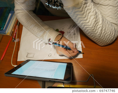 Photography a child doing homework. Concepts of education and development of children.and distance online education during coronavirus pandemic. Photography a child doing homework. Concepts of education and development of children.and distance online education during coronavirus pandemic. 69747746