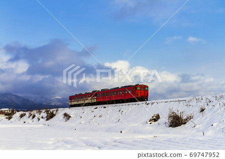 Diesel car running in a snowy landscape Kitakata City, Fukushima Prefecture 69747952