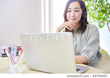 Woman having an online meeting in the living room 69748005
