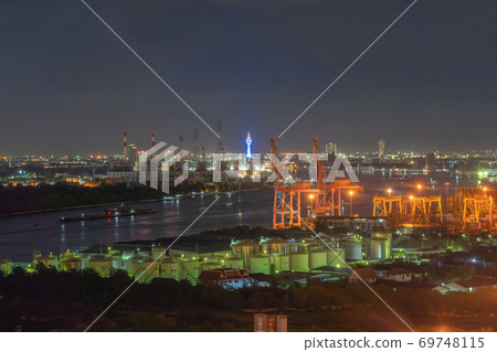 Aerial view of Samut Prakan Observation Tower and industry factory, river, cargo ship in the export and import business and logistics in urban city, Bangkok harbour, Thailand. Aerial view of Samut Prakan Observation Tower and industry factory, river, cargo ship in the export and import business and logistics in urban city, Bangkok harbour, Thailand. 69748115