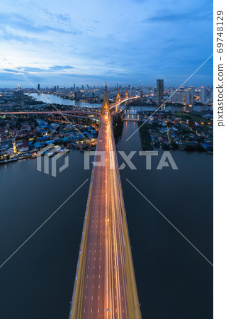 Aerial view of Bhumibol Bridge and Chao Phraya River in structure of suspension architecture concept, Urban city, Bangkok. Downtown area at night, Thailand. Aerial view of Bhumibol Bridge and Chao Phraya River in structure of suspension architecture concept, Urban city, Bangkok. Downtown area at night, Thailand. 69748129