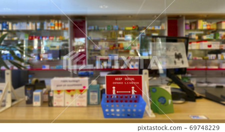 Blurred photo of Medicines arranged in shelves at pharmacy. Pharmacy during Covid-19. Blurred photo of Medicines arranged in shelves at pharmacy. Pharmacy during Covid-19. 69748229